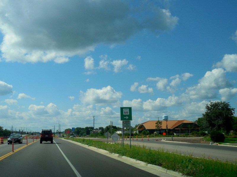 A car drives down a highway.