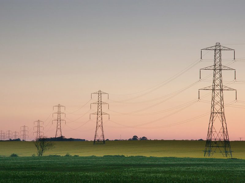 electrical wires crossing a rural landscape