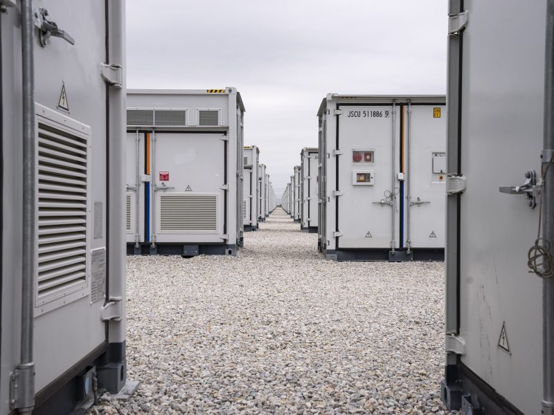 An array of large utility-scale batteries the size of storage containers at a facility in Texas.