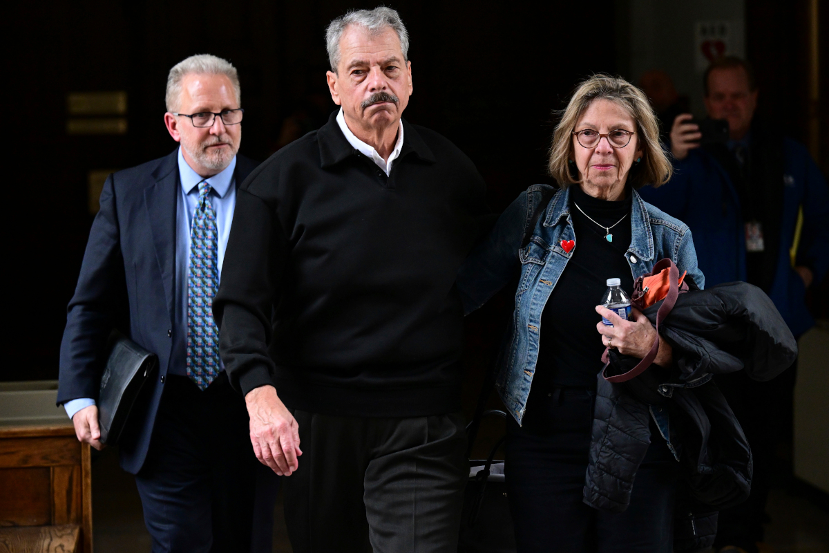 Former regulator Sam Randazzo leaves the court room along with his wife and lawyer following his Feb. 13 indictment.