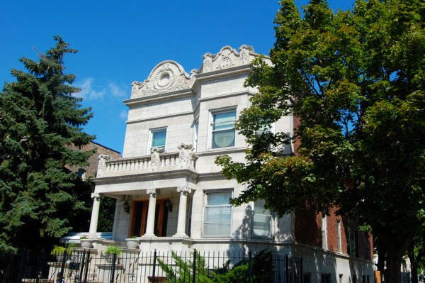 An ornate grey house surrounded by trees in Chicago