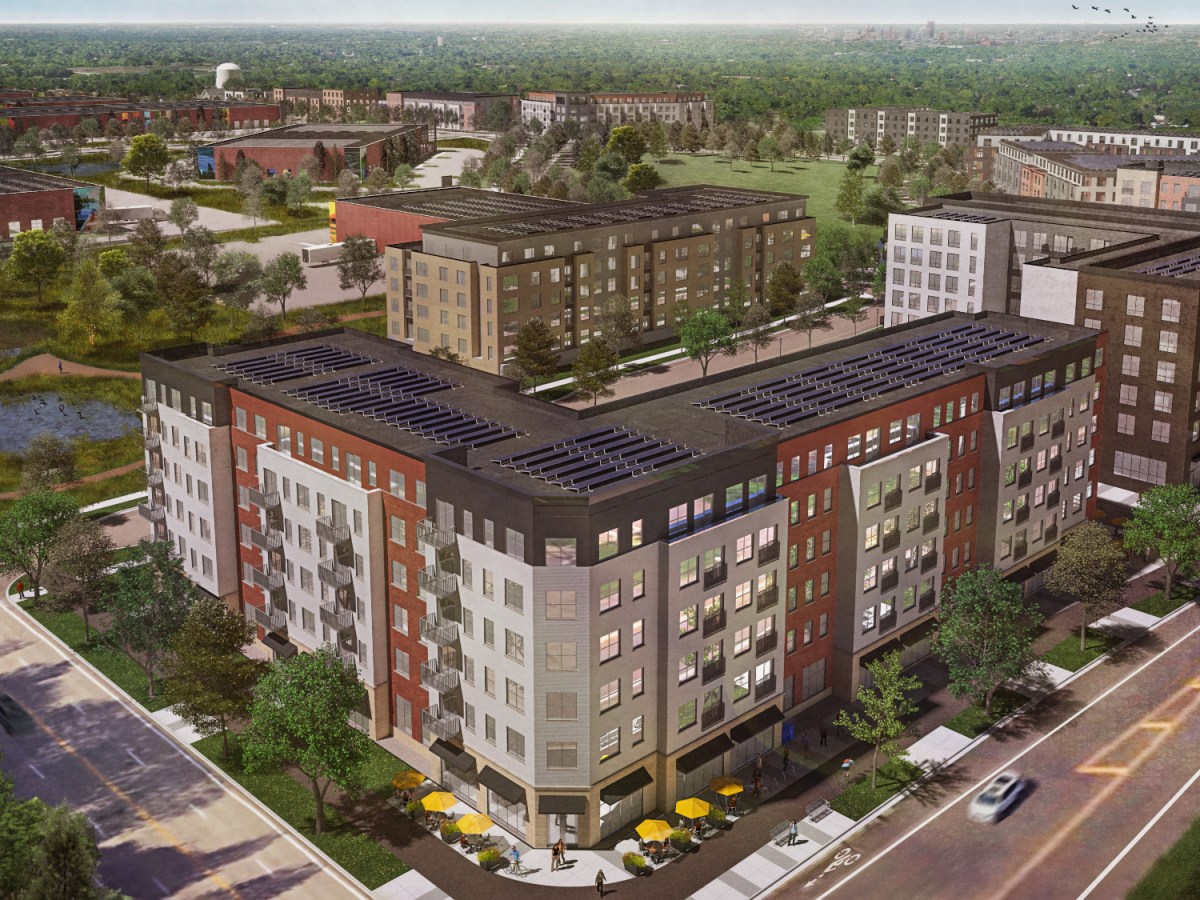 A rendering showing an aerial view of six-story block of apartments with solar panels on the roof.