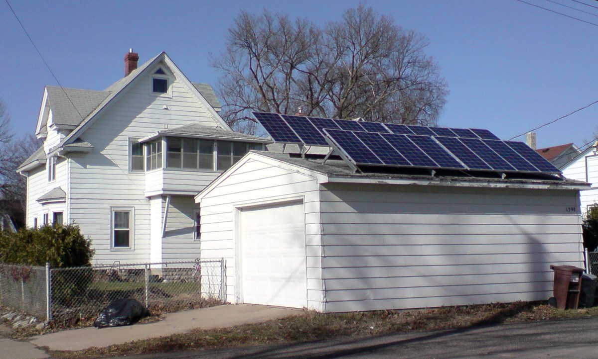 Solar panels on a detached garage behind an older home in Minneapolis.