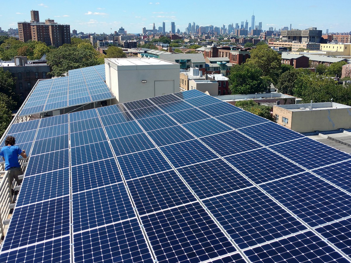 Solar panels on an apartment building rooftop.