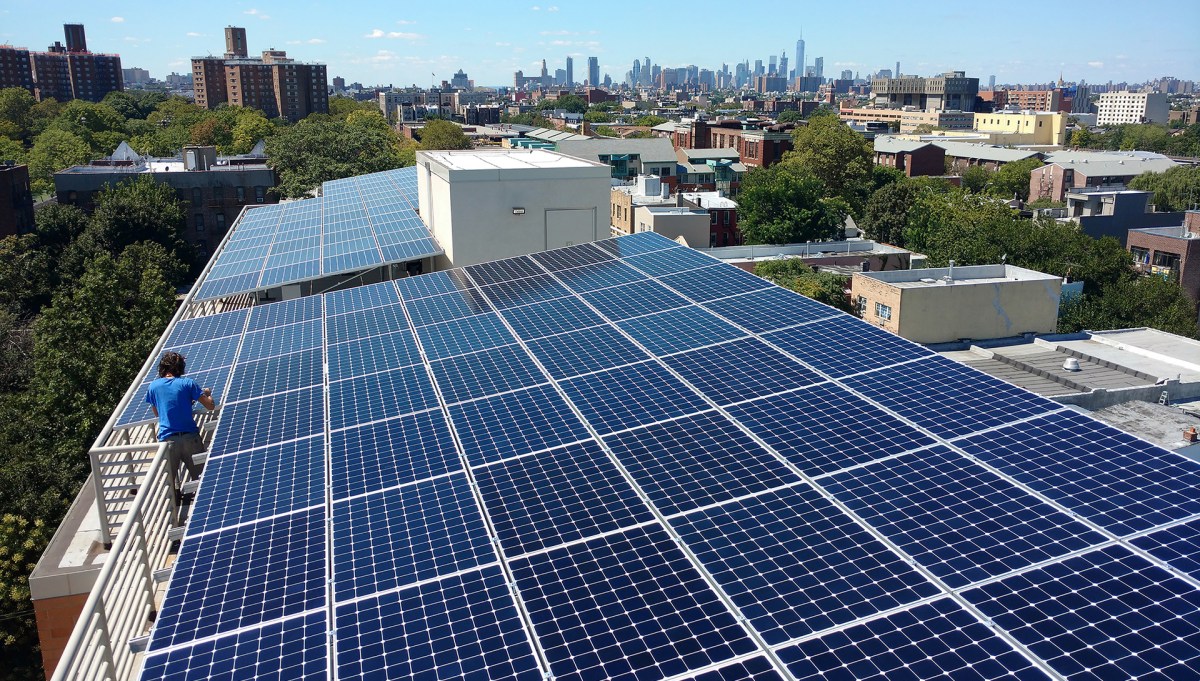 Solar panels on an apartment building rooftop.