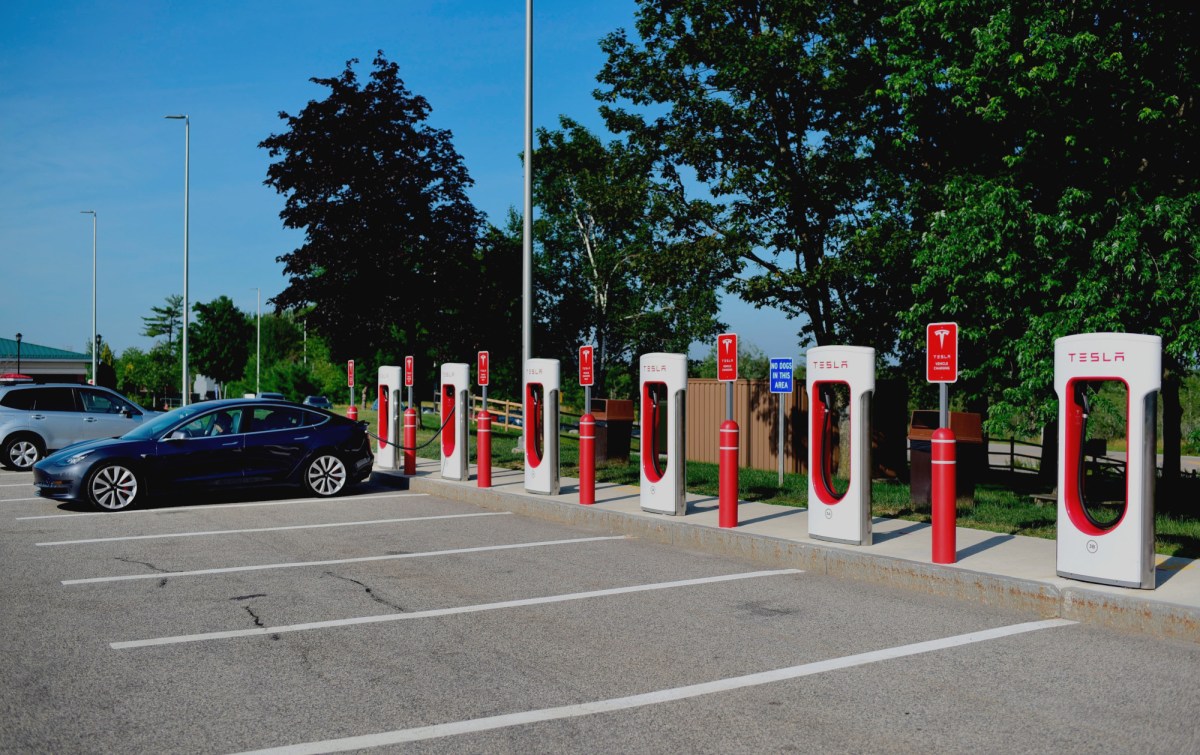 An electric vehicle charging station in Maine with one car and five empty stalls.